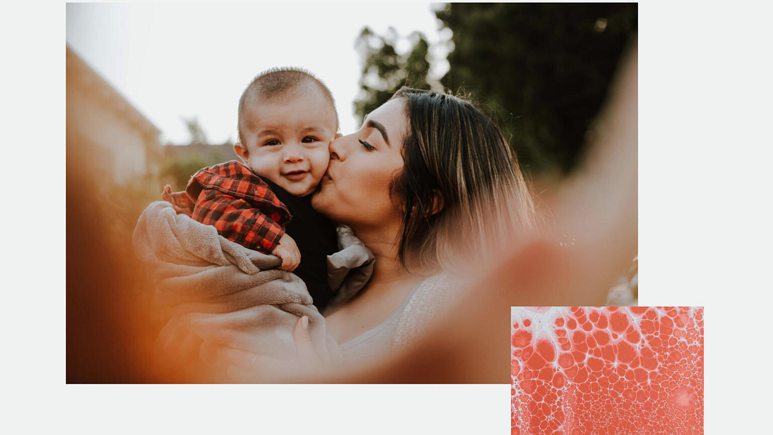 Woman kissing baby on the cheek.
