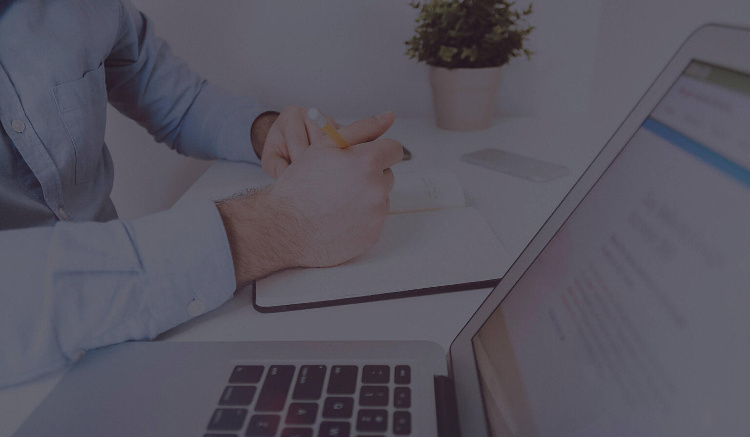 Medical professional using digital tablet and laptop.